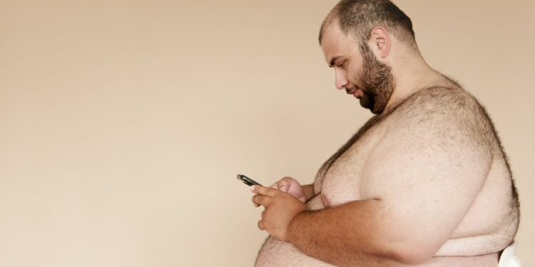 Topless Man Using Black Cellphone