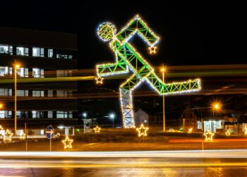 a building with christmas lights and a lit up figure