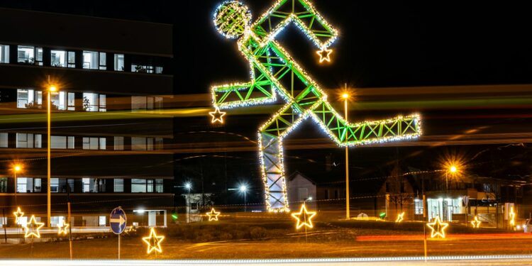 a building with christmas lights and a lit up figure