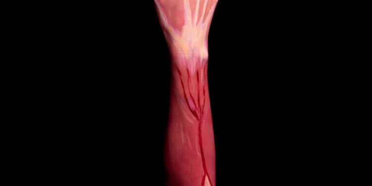 persons left hand with pink paint