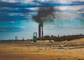 a factory with smoke coming out of it's stacks