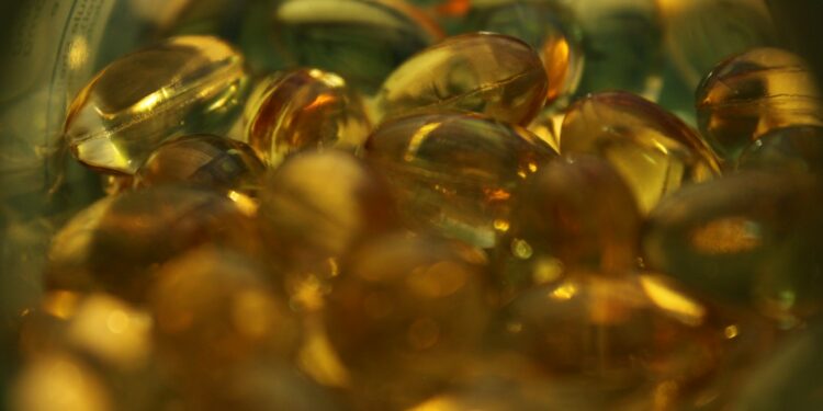 a glass bowl filled with lots of yellow and green pills