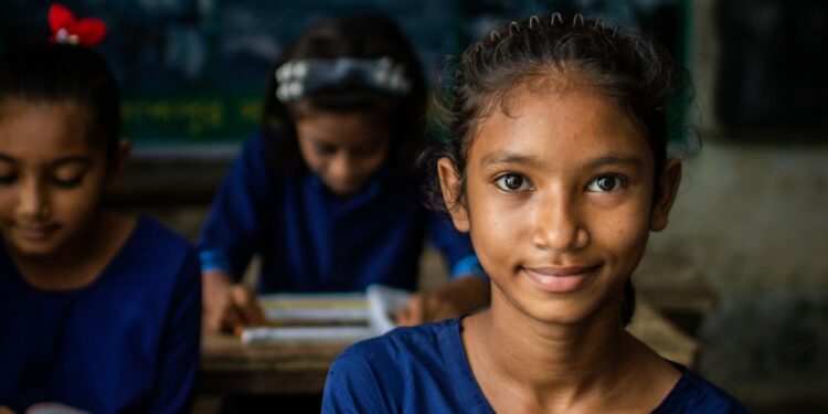 a few young girls in a classroom