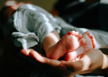 person holding baby feet