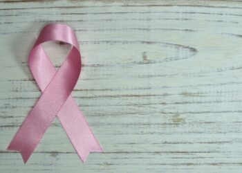 Breast Cancer Awareness on Teal Wooden Surface