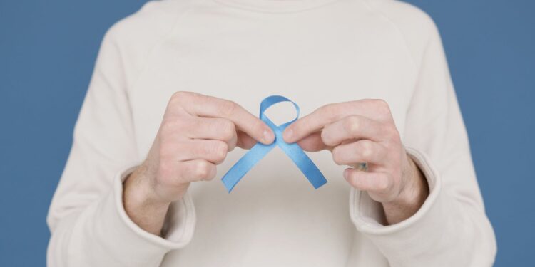 A person holding a blue awareness ribbon symbolizing support for various causes.