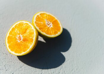 two oranges cut in half sitting on a table
