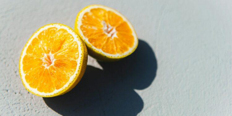two oranges cut in half sitting on a table