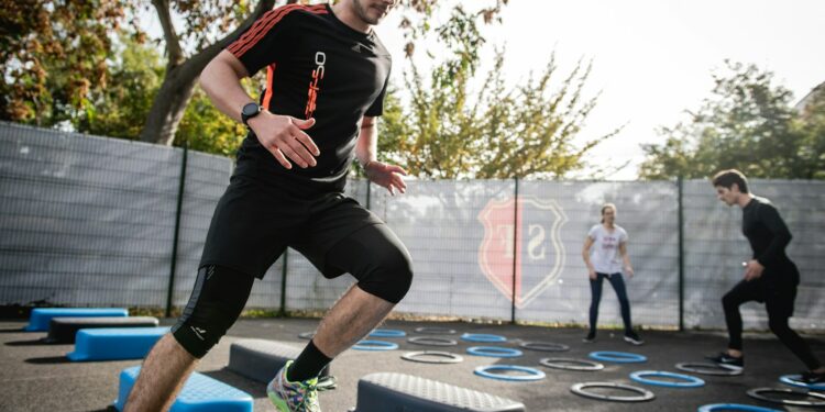 man in black crew neck t-shirt and black shorts running on blue and white trampoline
