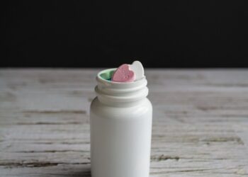 white plastic bottle on brown wooden table