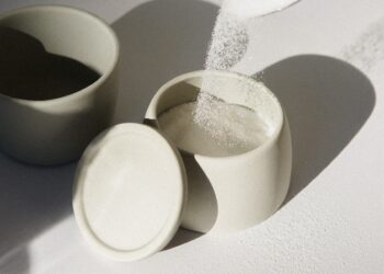 white ceramic mugs on white table