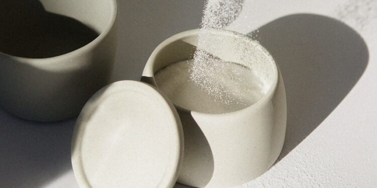 white ceramic mugs on white table