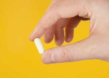 person holding white cigarette stick