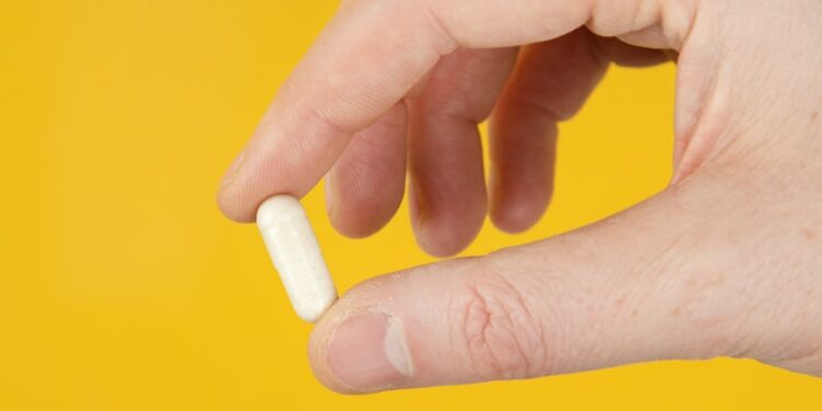 person holding white cigarette stick