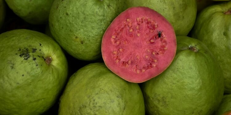 a pile of green and red fruit sitting on top of each other