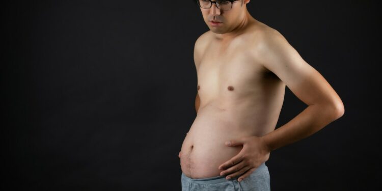 topless man in blue denim jeans
