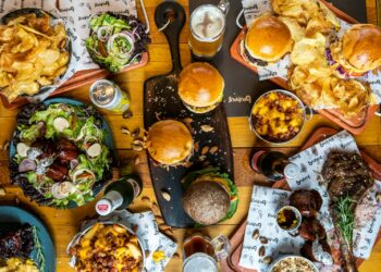 a wooden table topped with lots of food