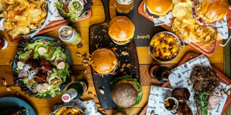 a wooden table topped with lots of food