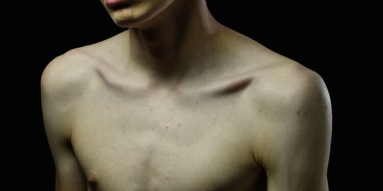 topless man with eyebrow piercing