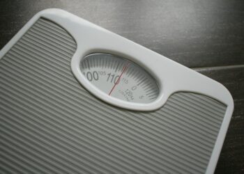 a bathroom scale sitting on top of a wooden table
