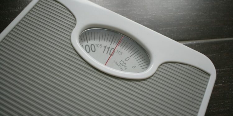 a bathroom scale sitting on top of a wooden table