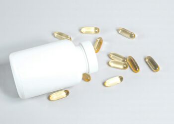 a bottle of pills spilling out of it