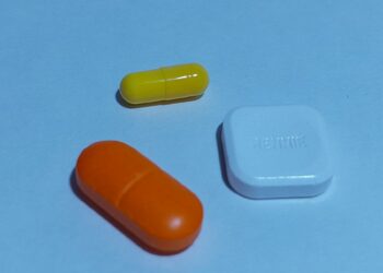 A group of three pills sitting next to each other