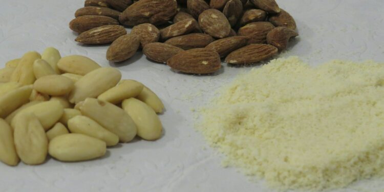 a pile of nuts next to a pile of rice