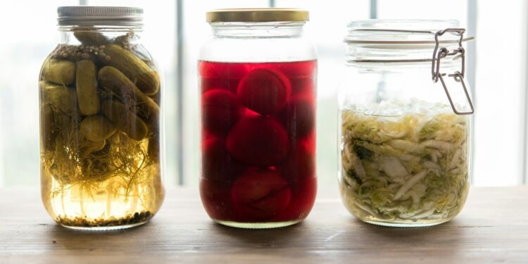 three jars filled with different types of food