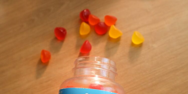 a bottle of gummy vitamins sitting on top of a wooden table