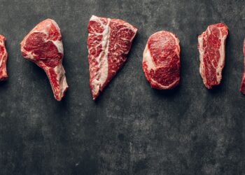 a group of raw meats laid out on a table