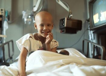child sitting on bed