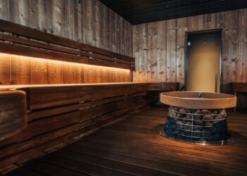 a wooden room with benches and a round table