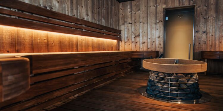 a wooden room with benches and a round table