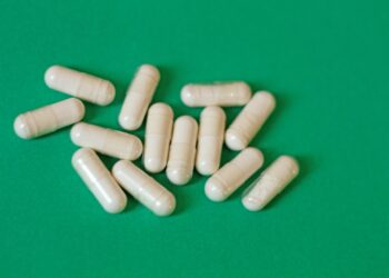 A pile of pills sitting on top of a green table