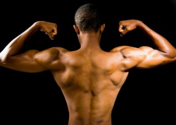 topless man with black background