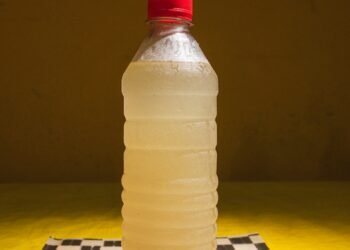 A bottle of water sitting on top of a checkered table