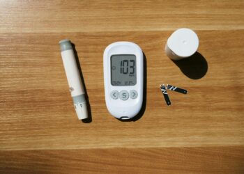 a thermometer, a pen, and a cup on a table