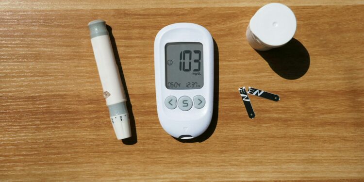 a thermometer, a pen, and a cup on a table