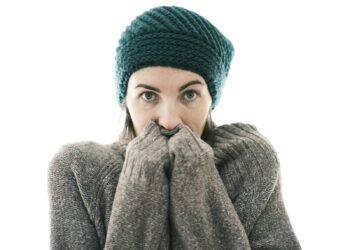 a woman covers her mouth with her hands