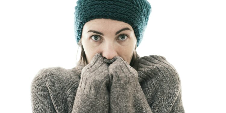 a woman covers her mouth with her hands