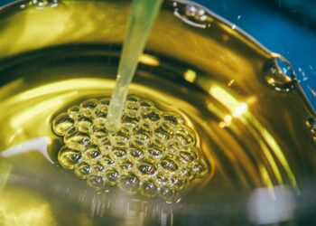 a metal bowl filled with yellow liquid