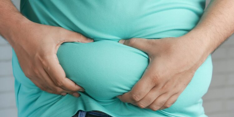 a man holding his stomach with his hands