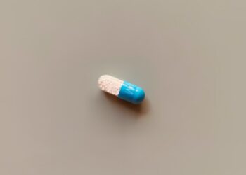 a blue and white pill sitting on top of a table