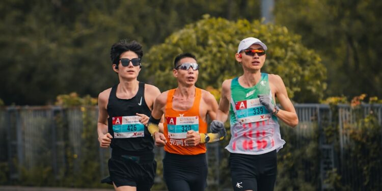 Three runners compete in a marathon race.