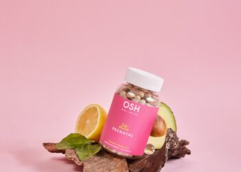 A jar of vitamins sitting on top of a pile of rocks